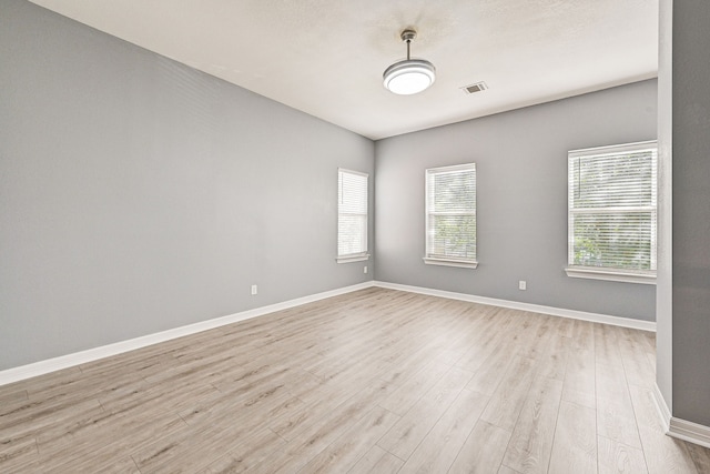 unfurnished room with light hardwood / wood-style flooring