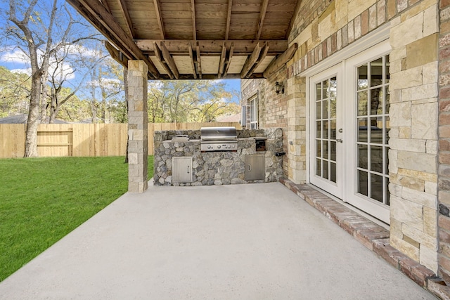 view of patio / terrace with exterior kitchen, grilling area, and french doors