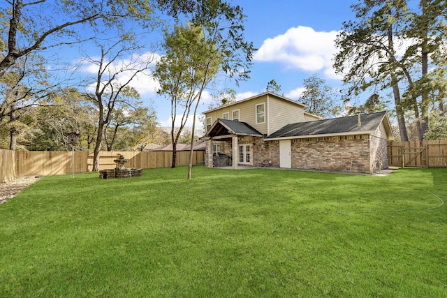 back of property featuring french doors and a yard