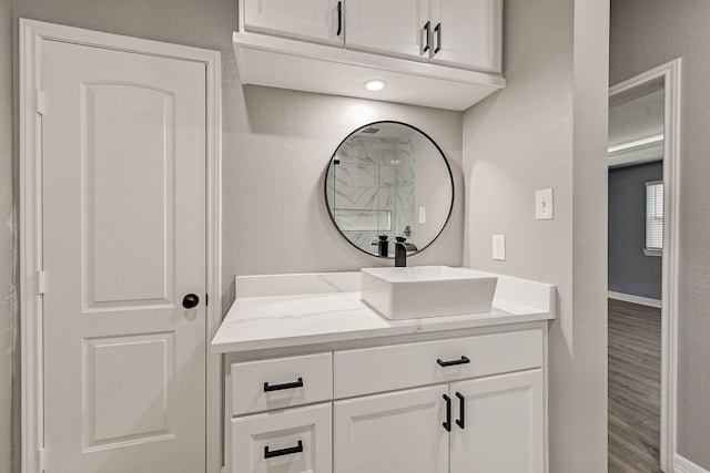 bathroom featuring vanity and hardwood / wood-style flooring