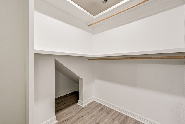 spacious closet featuring light hardwood / wood-style floors