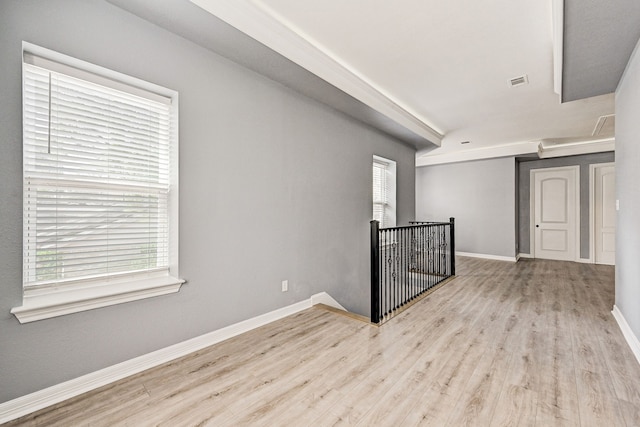 unfurnished room featuring light wood-type flooring and plenty of natural light