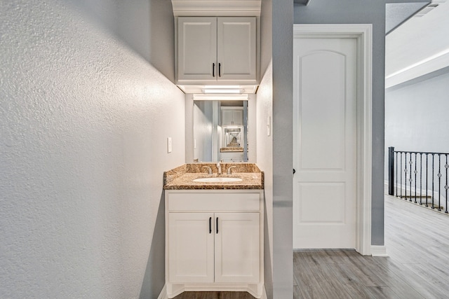 bathroom with vanity and hardwood / wood-style floors