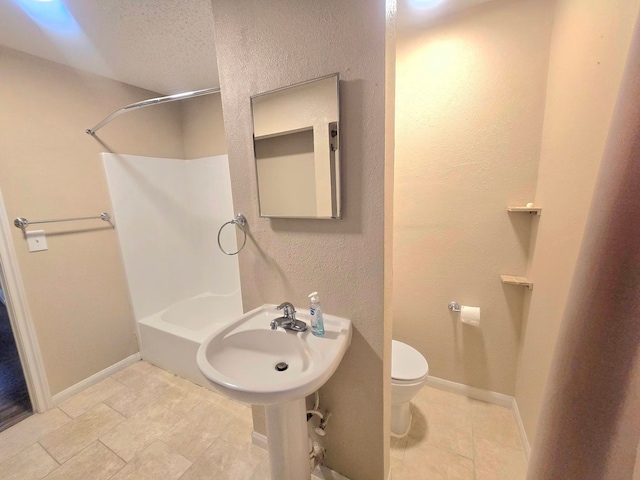 full bathroom featuring a textured ceiling,  shower combination, sink, and toilet