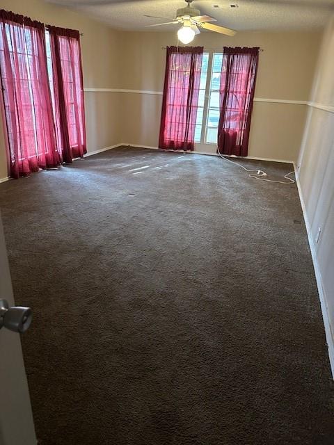 unfurnished room featuring ceiling fan and carpet flooring