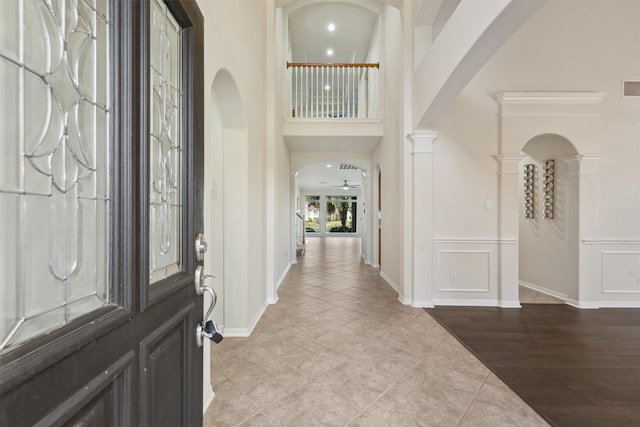 foyer with ceiling fan and light hardwood / wood-style floors