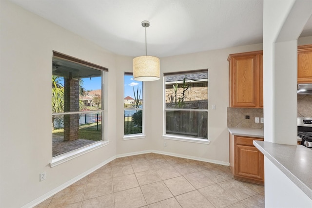 unfurnished dining area with light tile patterned flooring