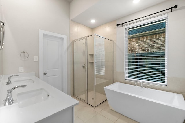 bathroom featuring separate shower and tub, vanity, and tile patterned floors