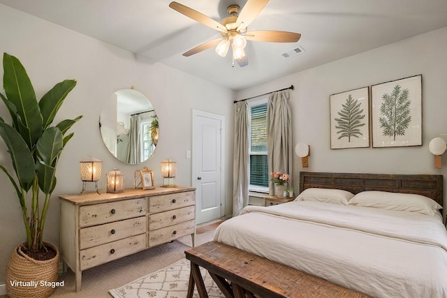 bedroom with light carpet and ceiling fan