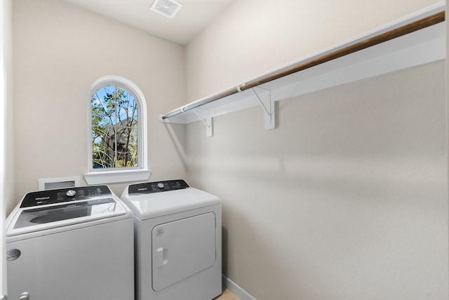 laundry area featuring washing machine and clothes dryer