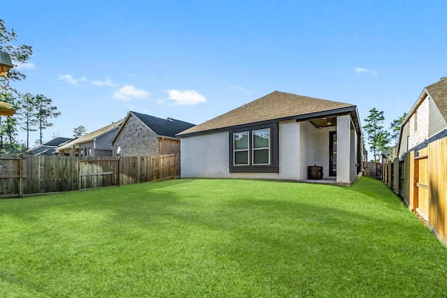 rear view of property featuring a yard