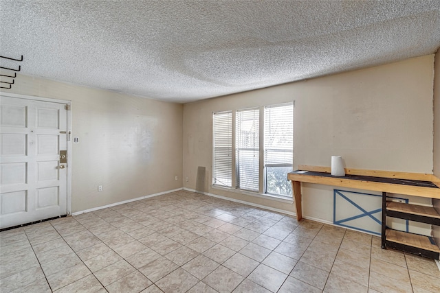 entryway featuring a textured ceiling and light tile patterned floors