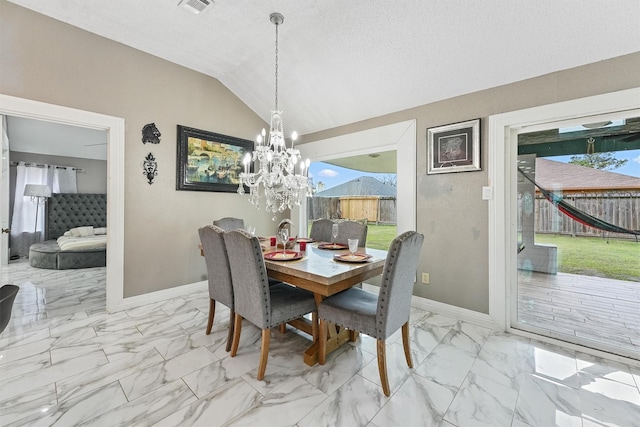 dining space with plenty of natural light, a textured ceiling, a notable chandelier, and vaulted ceiling