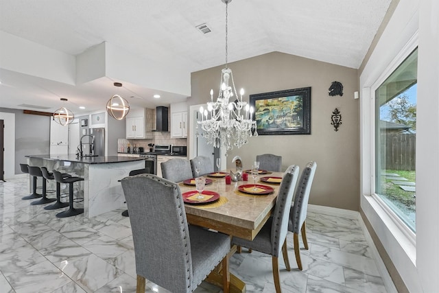 dining room with lofted ceiling and sink