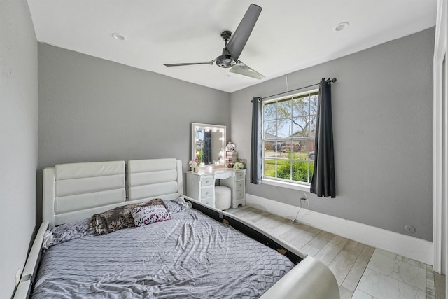 bedroom featuring a baseboard heating unit and ceiling fan