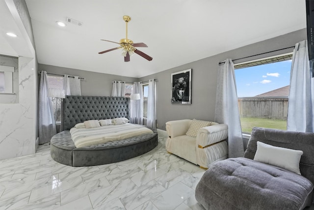 bedroom with ceiling fan and multiple windows