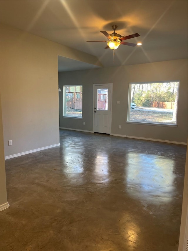 empty room featuring lofted ceiling and ceiling fan