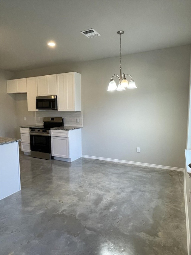 kitchen with a chandelier, appliances with stainless steel finishes, dark stone counters, white cabinetry, and decorative light fixtures