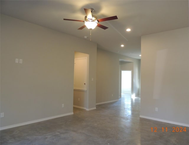 spare room with concrete flooring and ceiling fan