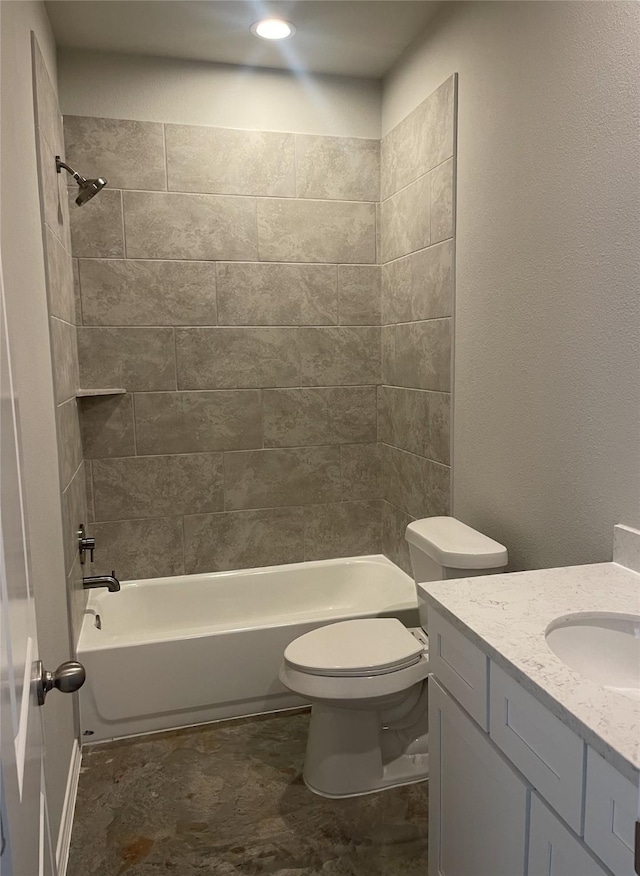 full bathroom featuring toilet, vanity, and tiled shower / bath