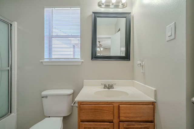 full bathroom with toilet, ceiling fan, vanity, and bath / shower combo with glass door