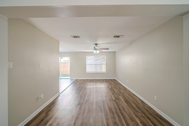 empty room featuring ceiling fan and dark hardwood / wood-style flooring