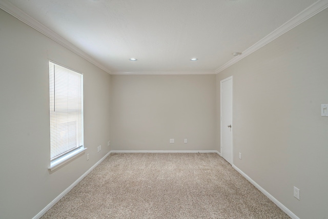 unfurnished room with ornamental molding and light carpet