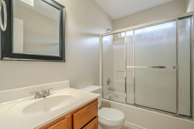 full bathroom featuring toilet, combined bath / shower with glass door, and vanity