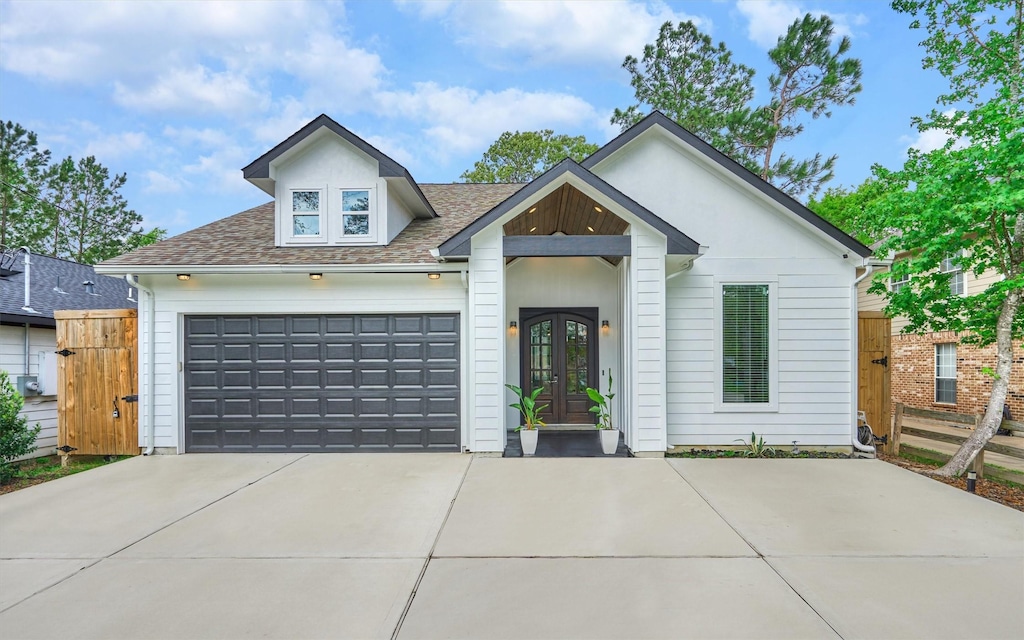 view of front of property featuring french doors and a garage