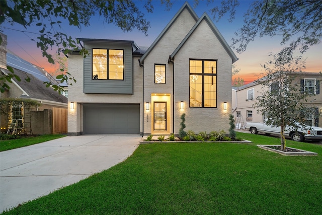 view of front of property featuring a lawn and a garage