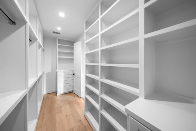 spacious closet with light hardwood / wood-style flooring