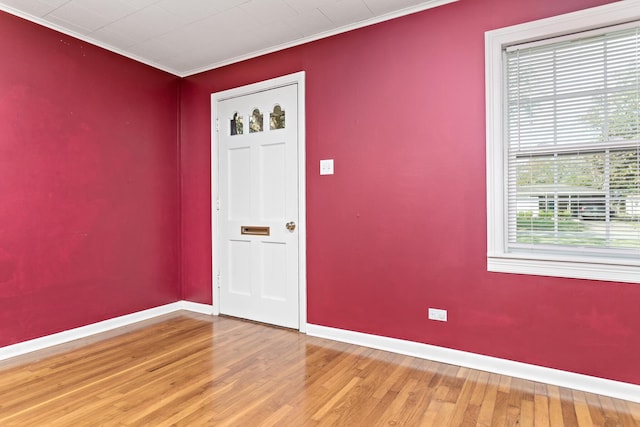 foyer with hardwood / wood-style floors and crown molding