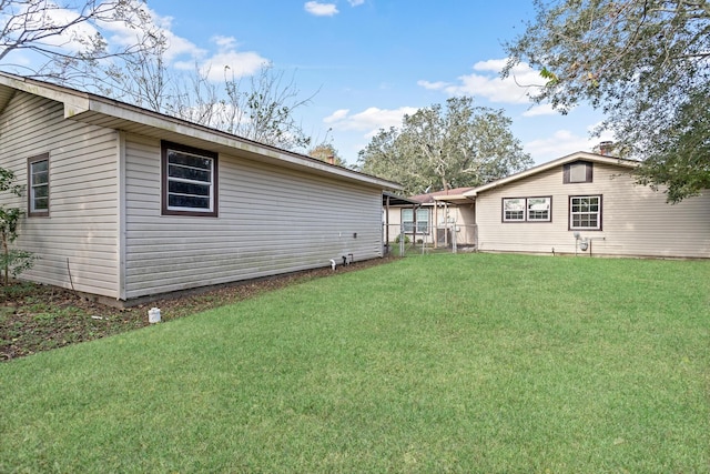 rear view of property featuring a lawn