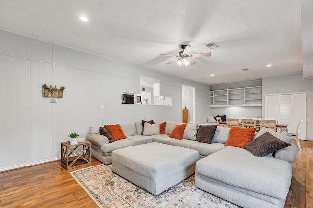 living room with hardwood / wood-style flooring and ceiling fan