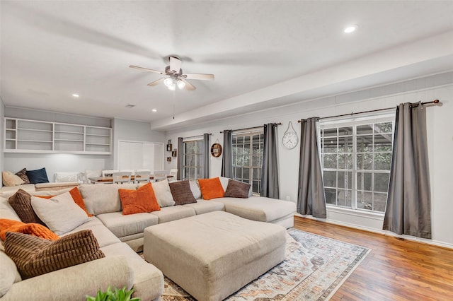 living room with ceiling fan and hardwood / wood-style flooring