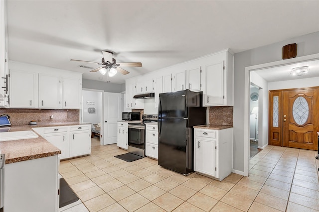 kitchen featuring white cabinetry, black appliances, decorative backsplash, and sink