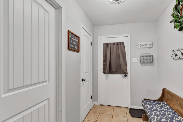 doorway with light tile patterned floors