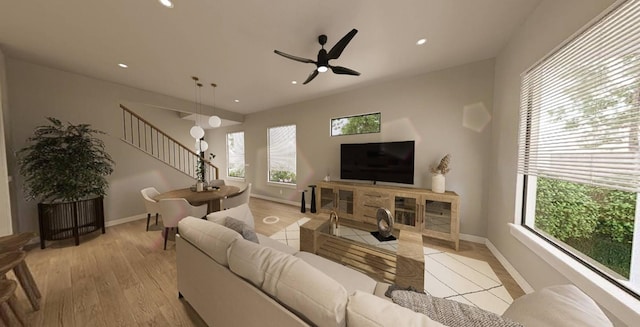 living room featuring ceiling fan and light hardwood / wood-style flooring