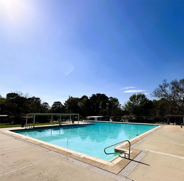 view of swimming pool with a patio