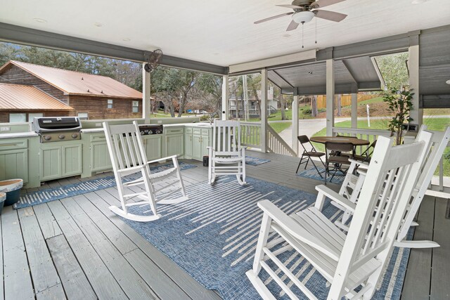 wooden deck with ceiling fan, an outdoor kitchen, and grilling area