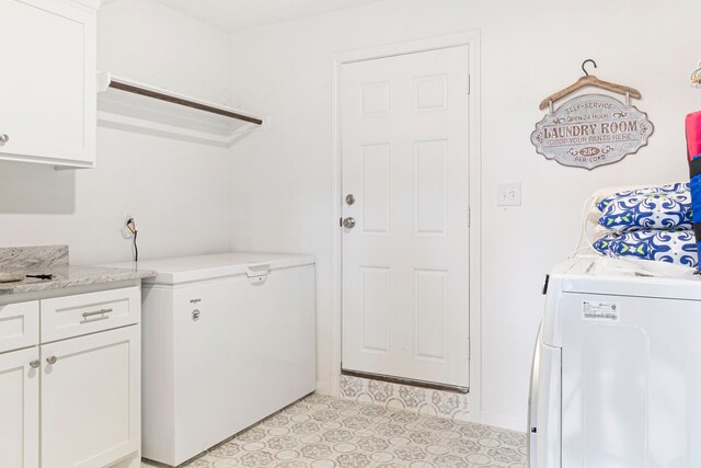 washroom featuring cabinets, light tile patterned floors, and separate washer and dryer