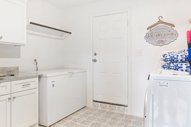 laundry room with independent washer and dryer and cabinets