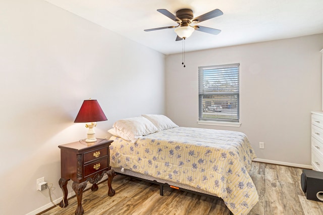 bedroom with ceiling fan and light hardwood / wood-style flooring