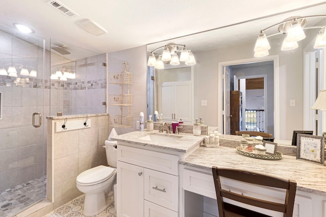 bathroom featuring vanity, toilet, and a shower with door