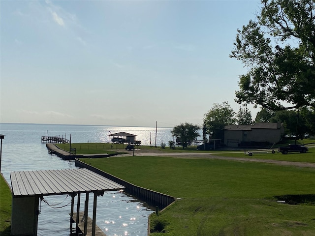 dock area featuring a water view and a yard