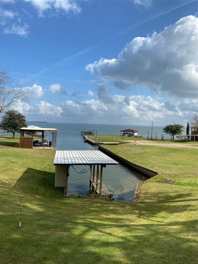 dock area with a water view and a yard