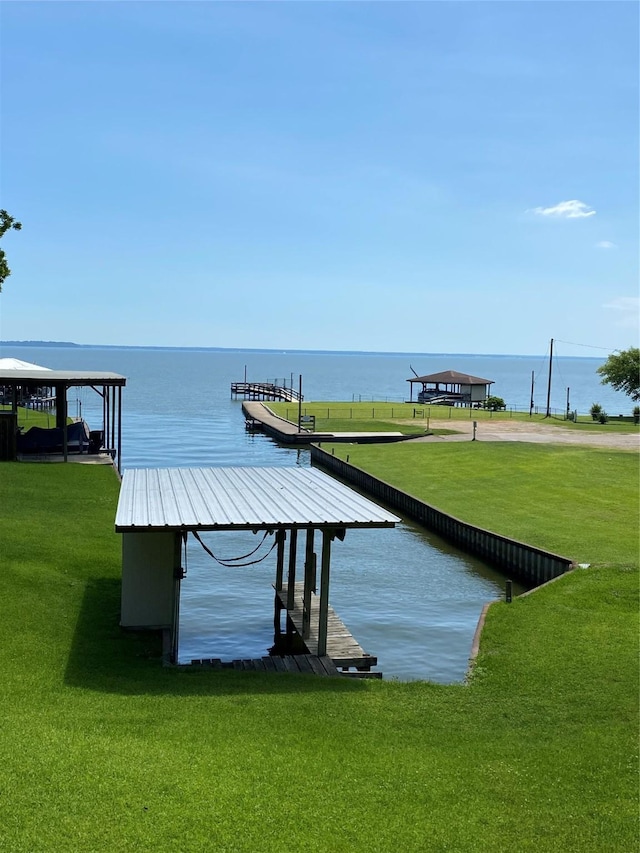 view of dock featuring a water view and a lawn