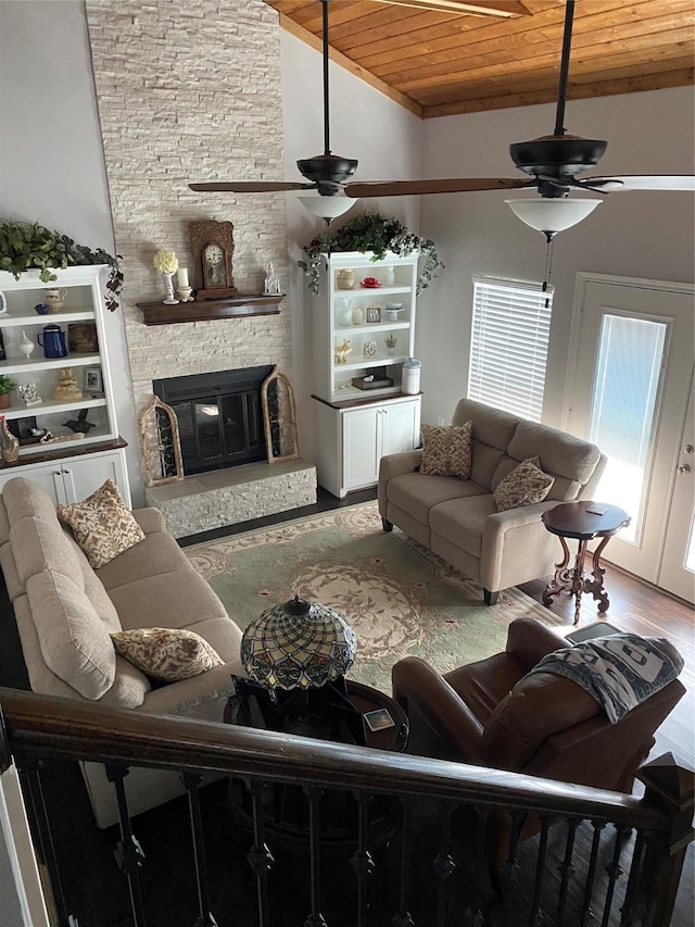 living room featuring hardwood / wood-style flooring, a fireplace, wooden ceiling, and ceiling fan