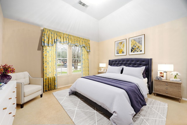 bedroom with light colored carpet and vaulted ceiling