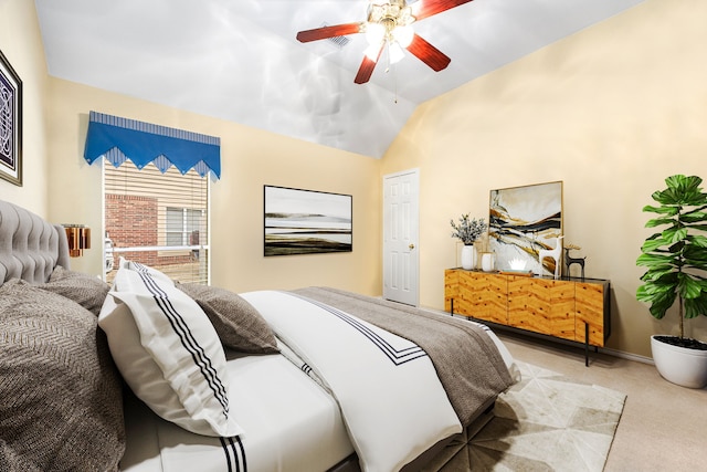 carpeted bedroom with ceiling fan and vaulted ceiling